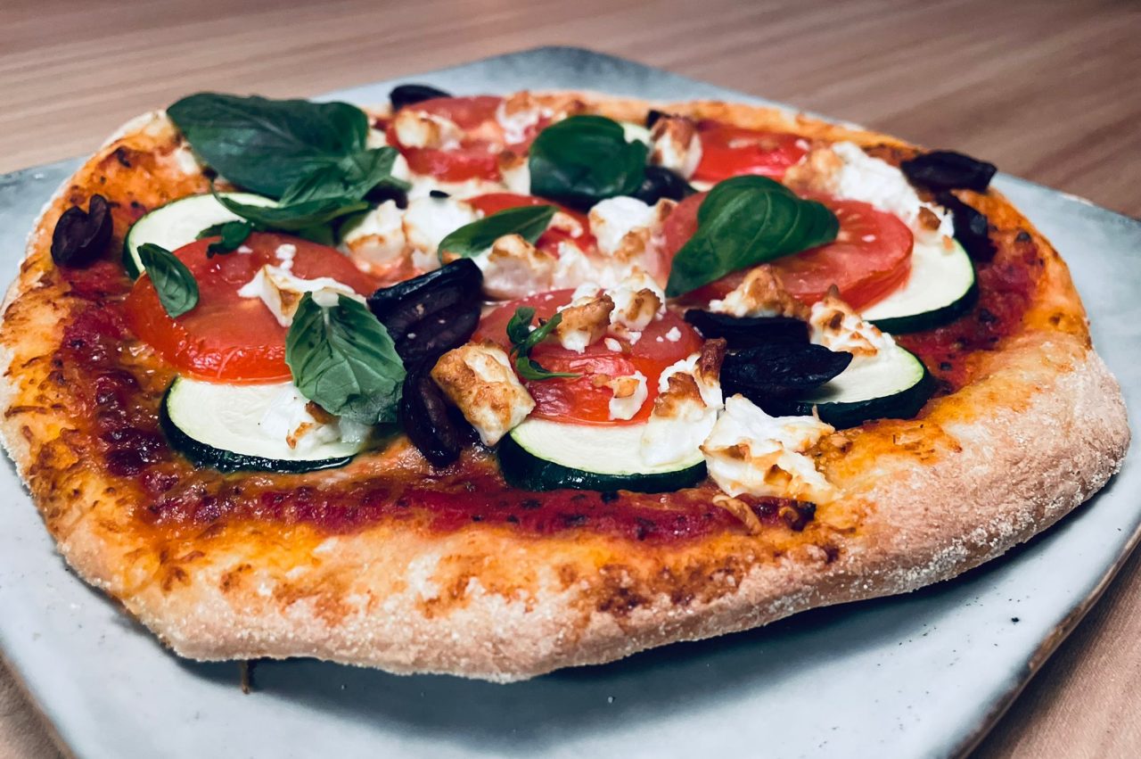 Pizza met courgette, tomaten, basilicum en mozzarella